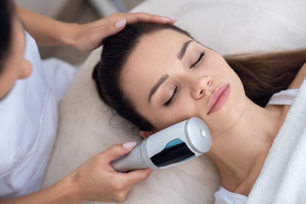 Young woman getting an ultrasound massage therapy