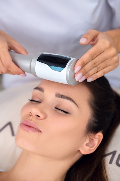 Young woman getting an ultrasound massage therapy