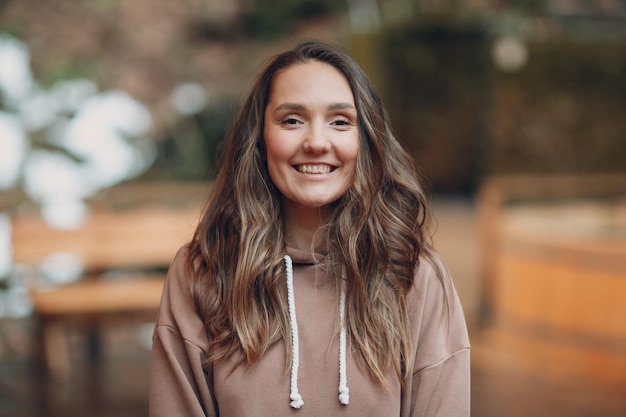 Young woman girl portrait Caucasian female smiling happy outside in spring park