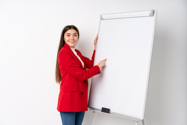 Young woman giving a presentation on white board giving a presentation on white board