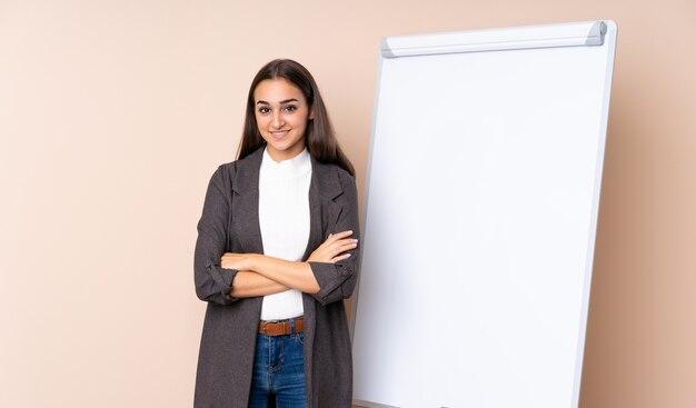 Young woman giving a presentation on white board smiling a lot