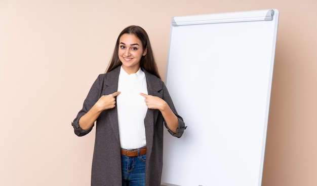 Young woman giving a presentation on white board with surprise facial expression