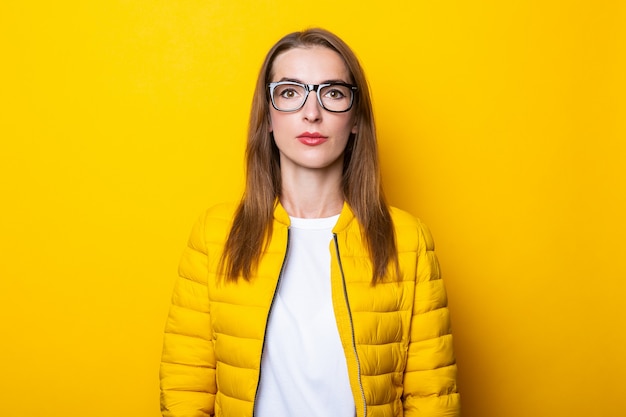 young woman in glasses and yellow jacket