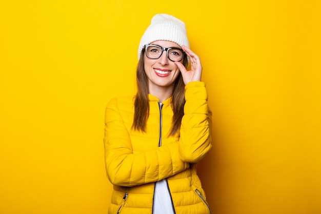 Young woman in glasses and yellow jacket