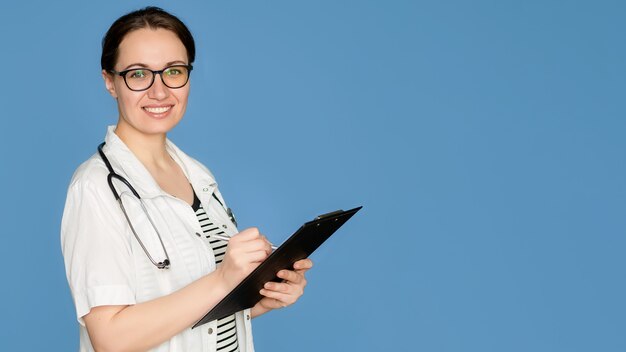 Young woman in gloves for cleaning on an isolated blue background