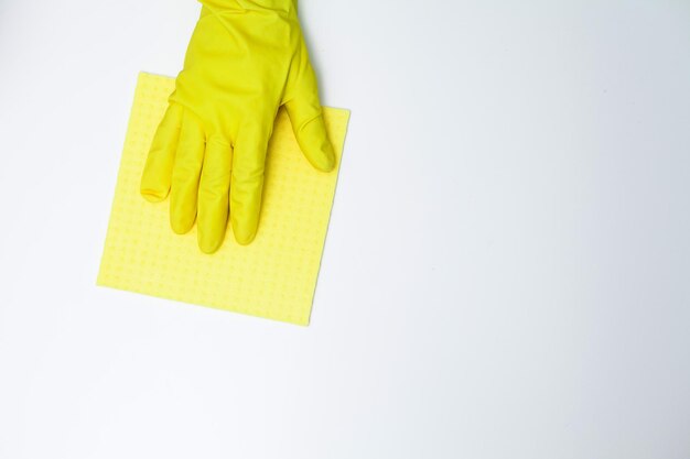 Young woman in gloves cleaning office table.