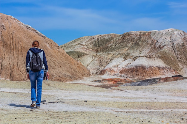 Young woman goes to Ural refractory clay quarries. Nature of Ural mountains