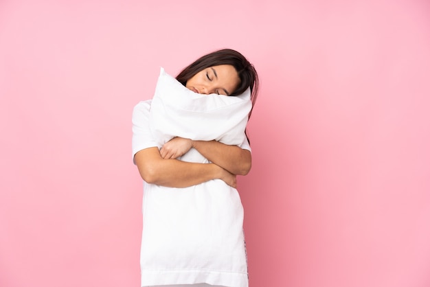 Young woman going to sleep over isolated wall