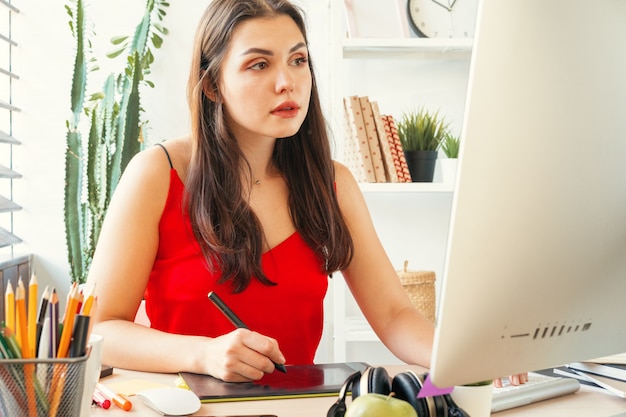 Grafico della giovane donna sul lavoro nel suo ufficio