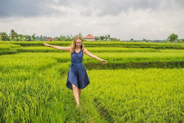 Young woman on Green cascade rice field plantation. Bali, Indonesia