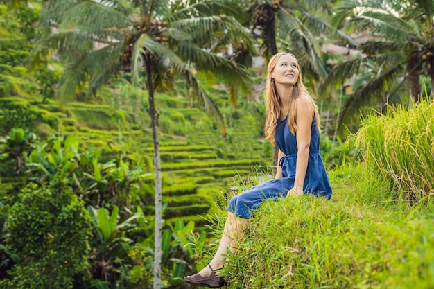 Young woman on Green cascade rice field plantation at Tegalalang terrace. Bali, Indonesia