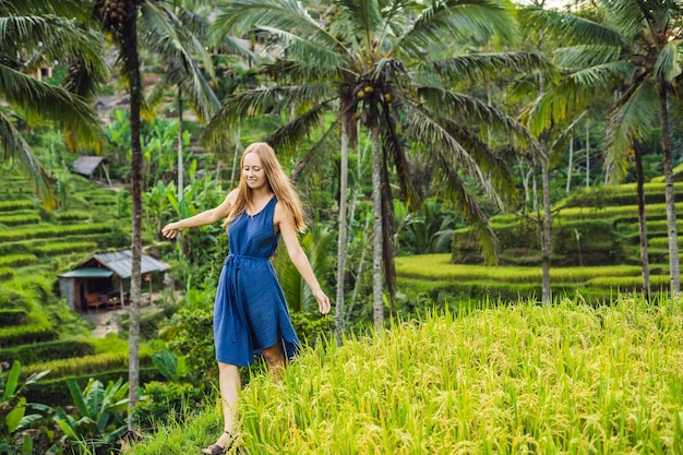 Young woman on Green cascade rice field plantation at Tegalalang terrace. Bali, Indonesia