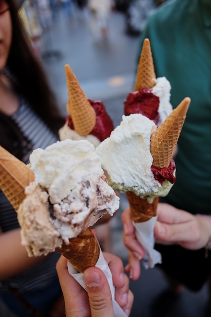 Young woman hands holding ice cream cones on summer