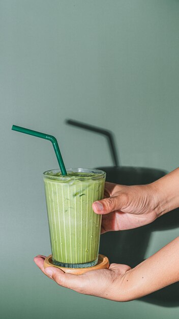 Young woman hands holding Milk green tea cold on white background copy space close up