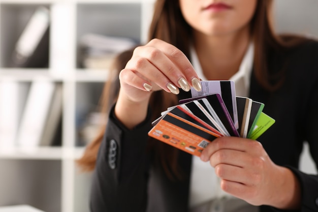 Young woman hands holding various bank cards