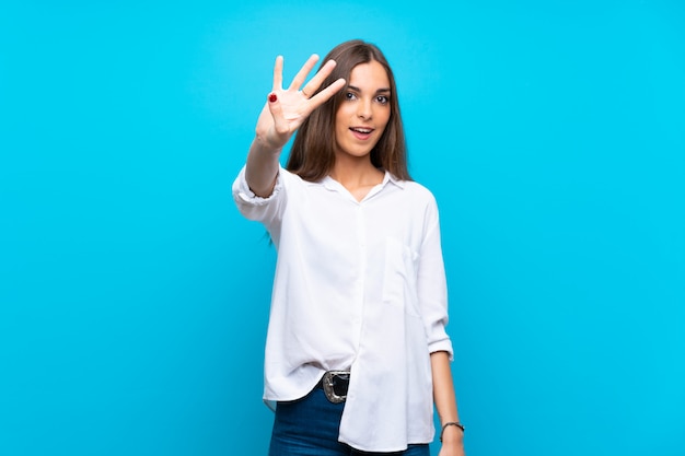 Young woman happy and counting four with fingers