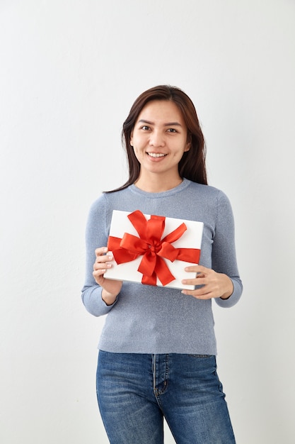 Young woman happy hold gift box in hands