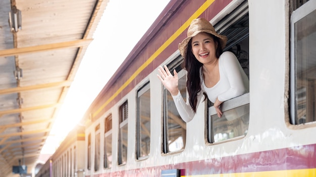 Young woman happy traveling on holiday by train