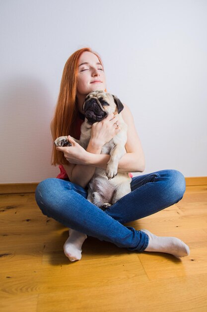 The young woman has a great time with her favorite pug