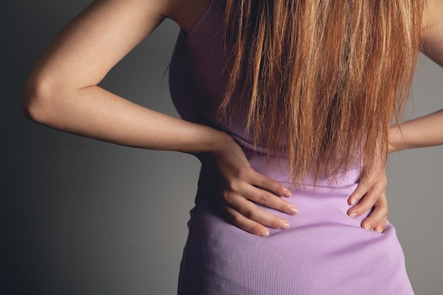 A young woman has a kidney pain