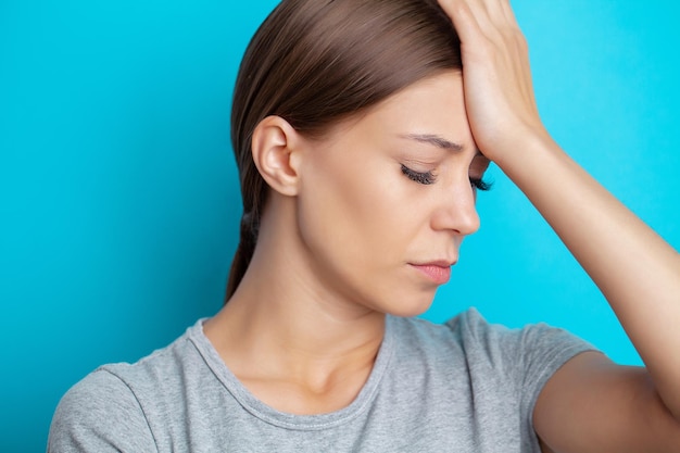 A young woman has a severe headache