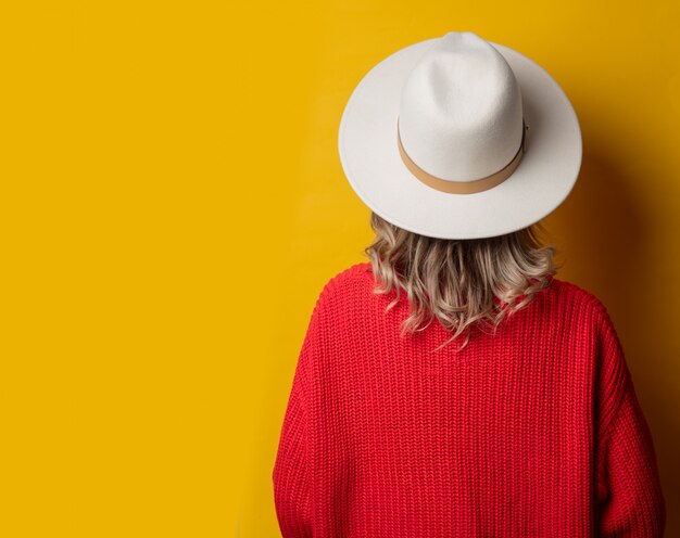 Young woman in hat and red sweater 