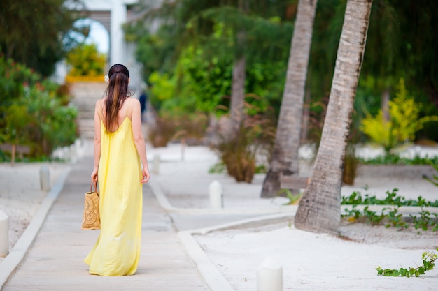 Young woman in hat during tropical beach vacation