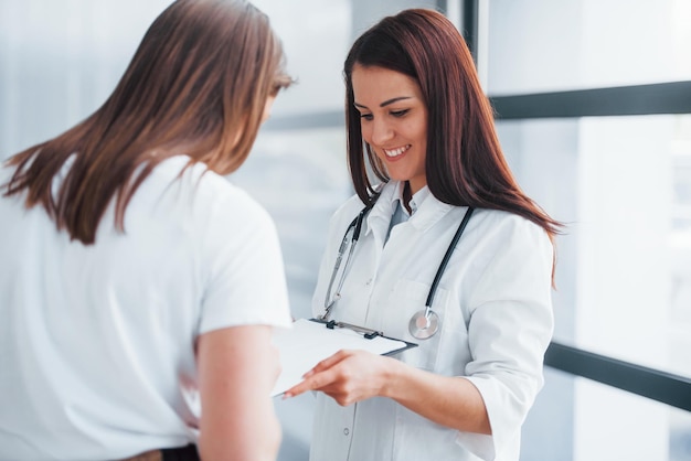 young woman have a visit with female doctor in modern clinic