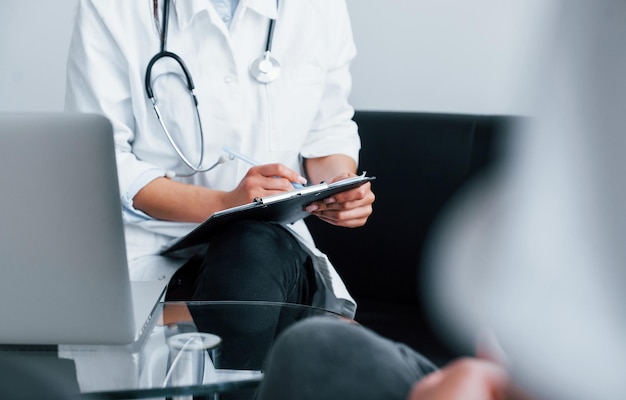 Young woman have a visit with female doctor in modern clinic