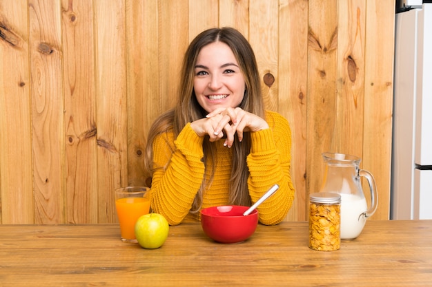 Young woman having breakfast in a kitchen