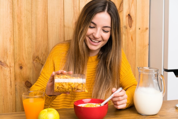 Young woman having breakfast in a kitchen