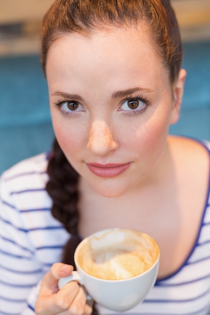 Young woman having a cappuccino