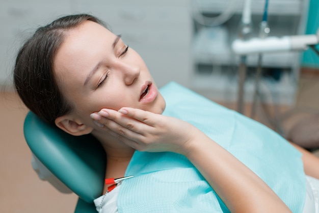 young woman having dental treatment at dentists office