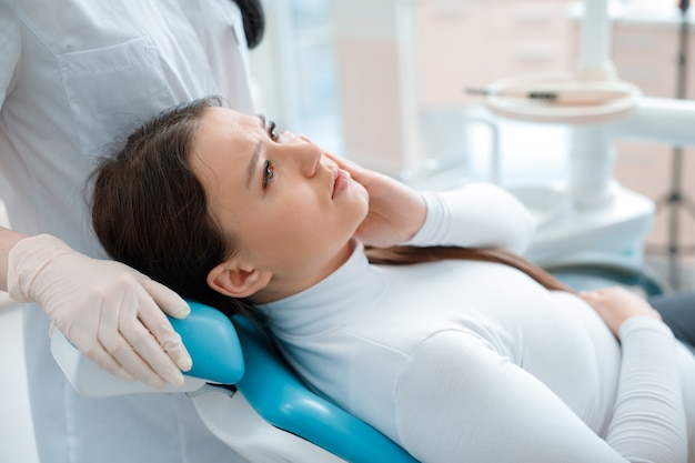 young woman having dental treatment at dentists office