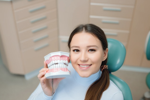 young woman having dental treatment at dentists office