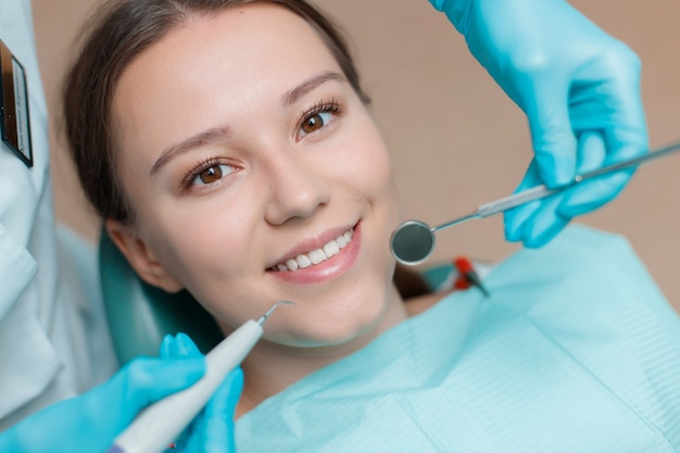 young woman having dental treatment at dentists office