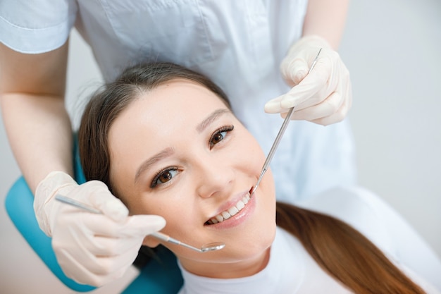 young woman having dental treatment at dentists office