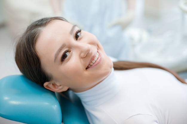 young woman having dental treatment at dentists office