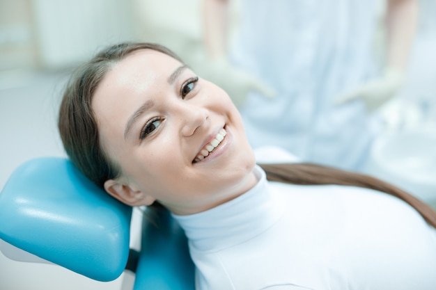 young woman having dental treatment at dentists office