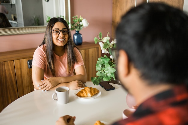 Young woman having food at home