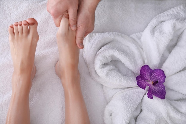 Young woman having foot massage in spa salon closeup