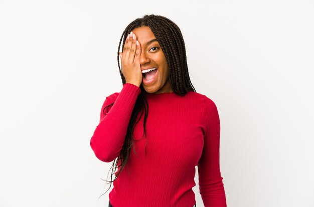 Young woman having fun covering half of face with palm