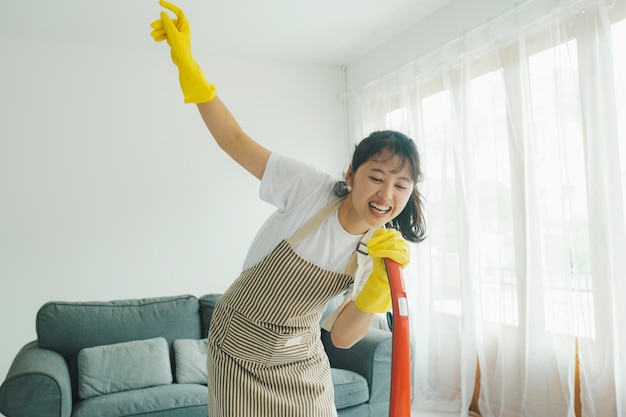 집을 청소하는 동안 즐거운 시간을 보내는 젊은 여성