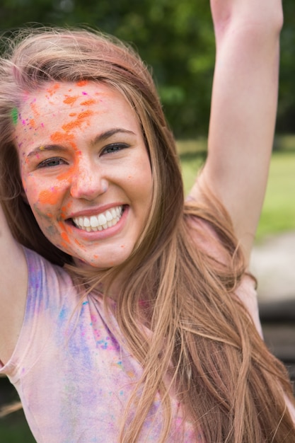 Young woman having fun with powder paint