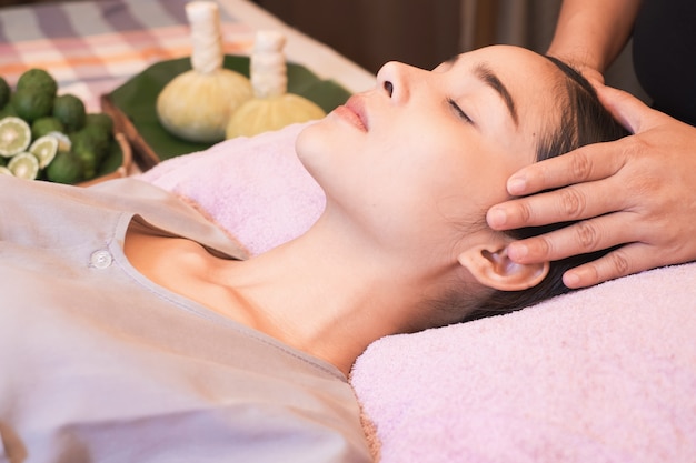 Young woman having her head massaged