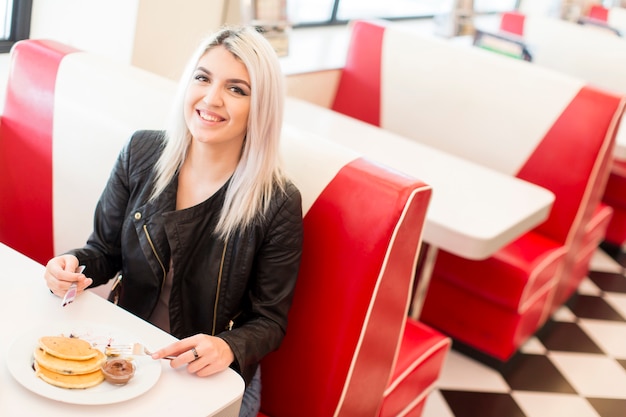 Young woman having lunch in a diner