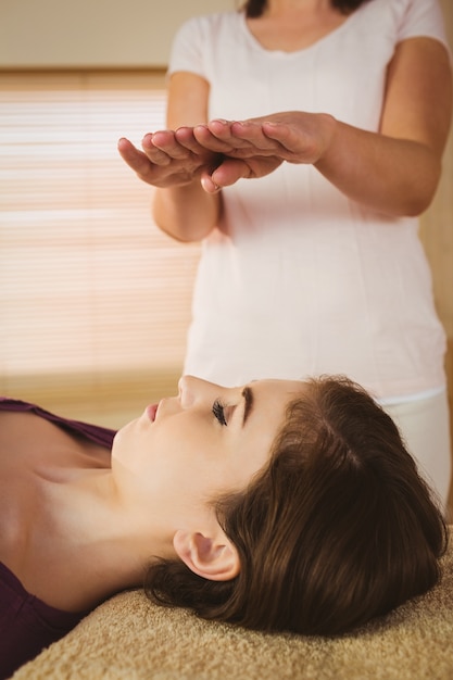 Young woman having a reiki treatment