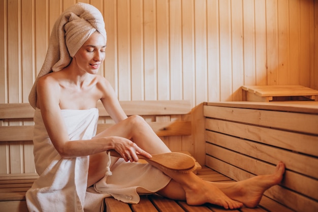 Young woman having rest in sauna alone