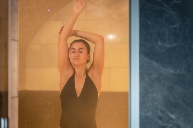 A young woman having rest in sauna alone