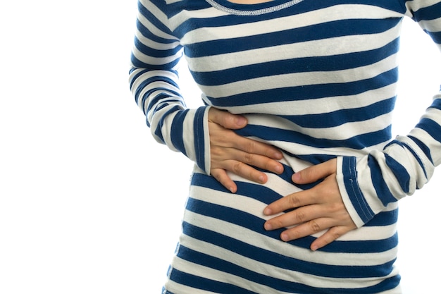 young woman having stomachache on white background